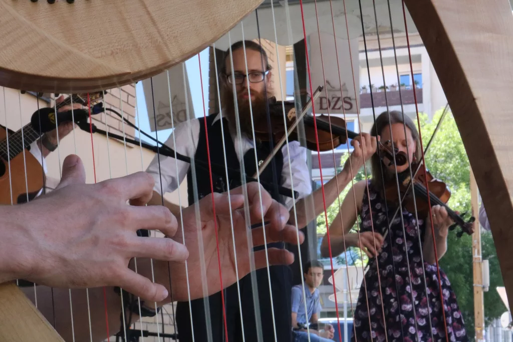 3 people playing Irish music and the irish harp