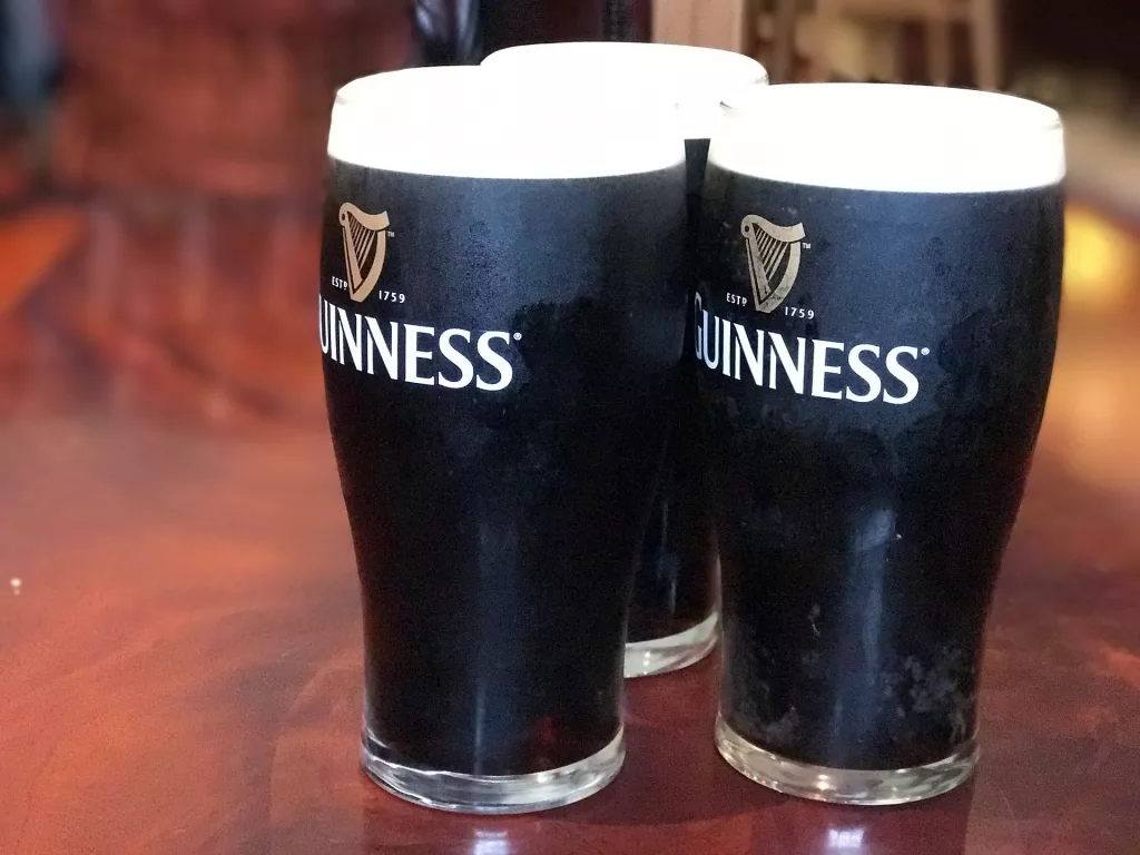 3 x pints of guinness on a table