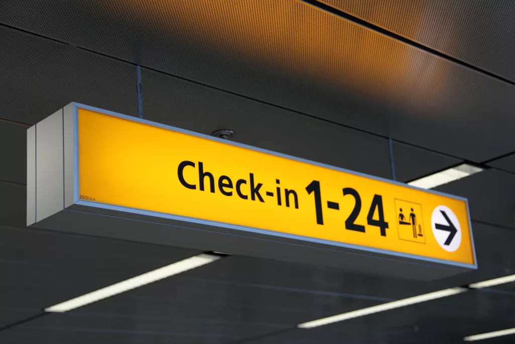 airport check in sign lighting in yellow