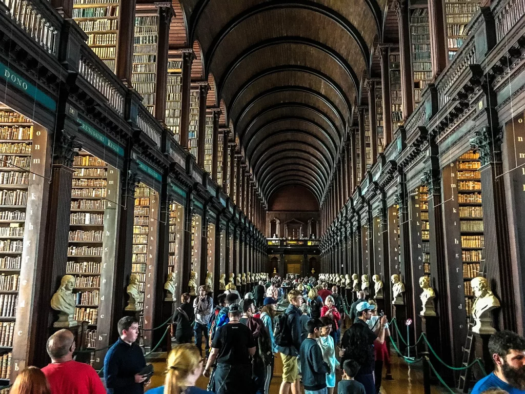 lots of people in the long library looking at the book of kells
