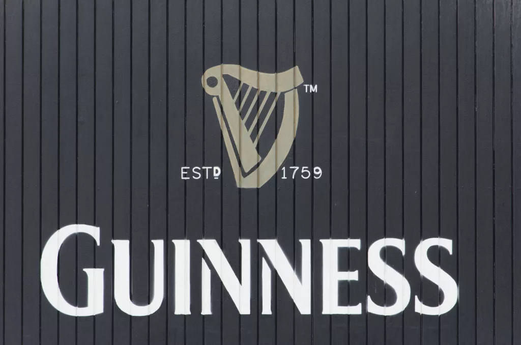 the guinness logo of the harp on a timber door